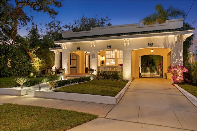 view of front of home featuring covered porch and a yard