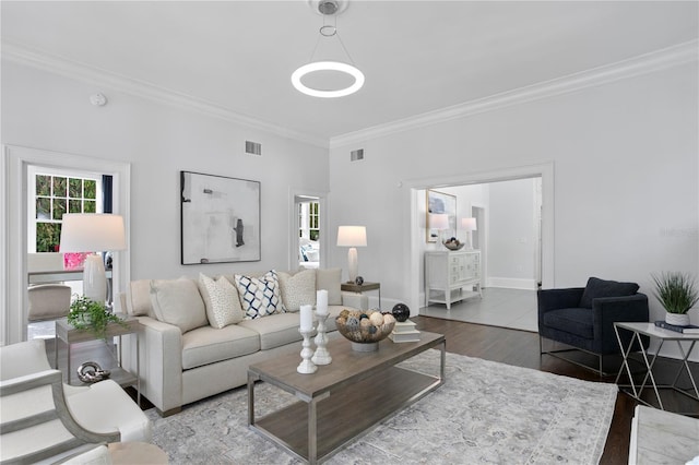 living room with wood-type flooring and ornamental molding