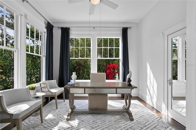 sunroom featuring ceiling fan