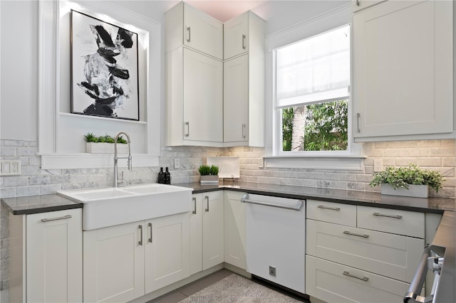 kitchen with white cabinets, dishwasher, backsplash, and sink