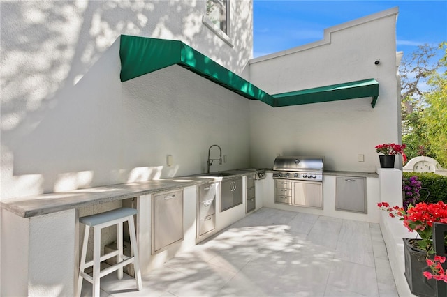 view of patio / terrace featuring a grill and sink