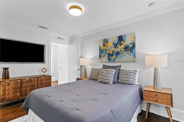 bedroom with ornamental molding and dark wood-type flooring