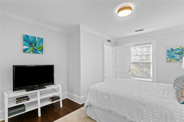 bedroom featuring crown molding and dark wood-type flooring