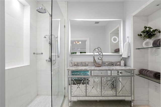 bathroom with vanity and tiled shower