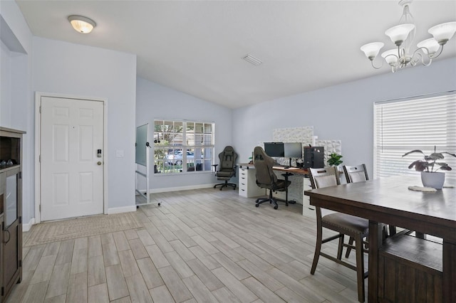 home office featuring a chandelier, light hardwood / wood-style floors, and vaulted ceiling