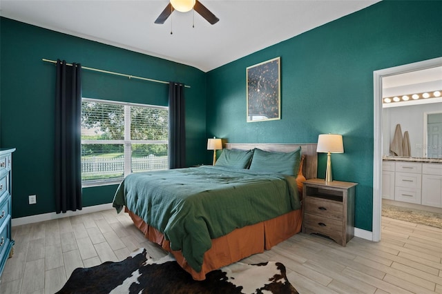 bedroom with ceiling fan, light wood-type flooring, and connected bathroom