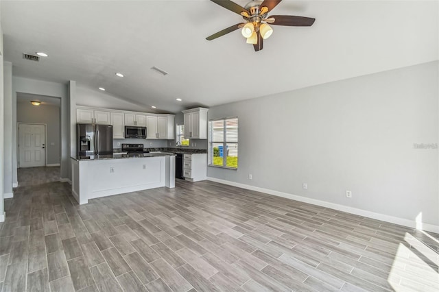 kitchen featuring lofted ceiling, black appliances, white cabinets, light hardwood / wood-style flooring, and ceiling fan