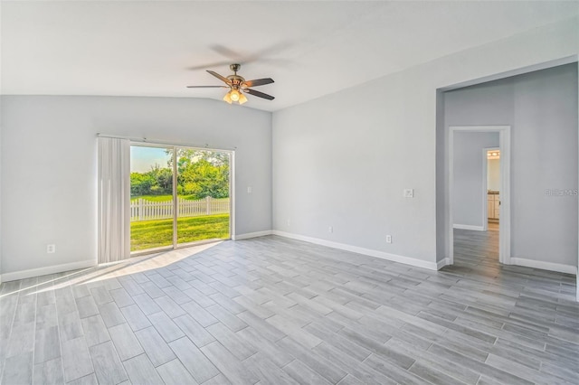 empty room with ceiling fan, light hardwood / wood-style floors, and vaulted ceiling