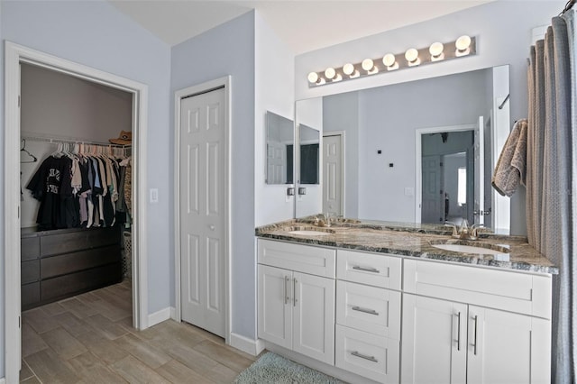 bathroom featuring hardwood / wood-style floors, vanity, and walk in shower