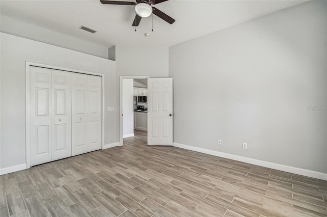 unfurnished bedroom with a closet, ceiling fan, and light hardwood / wood-style flooring