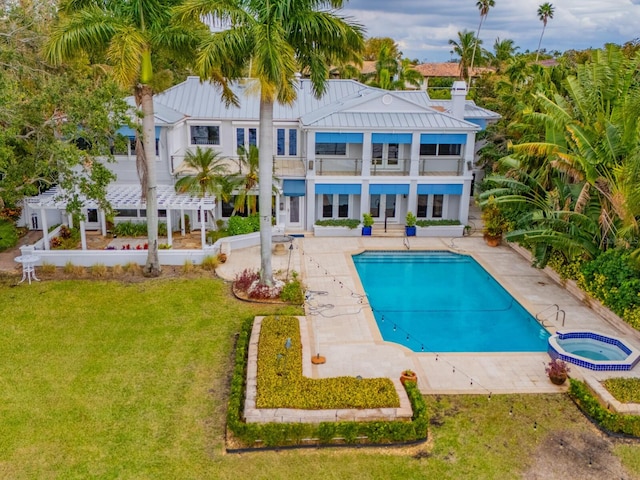 view of swimming pool featuring an in ground hot tub, a yard, and a patio