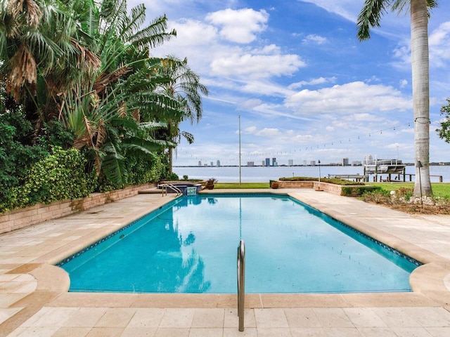 view of swimming pool featuring a water view