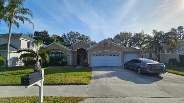 view of front of property with a garage and a front lawn