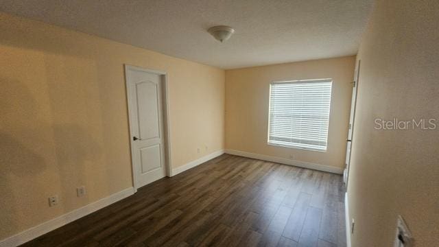 empty room featuring dark hardwood / wood-style flooring