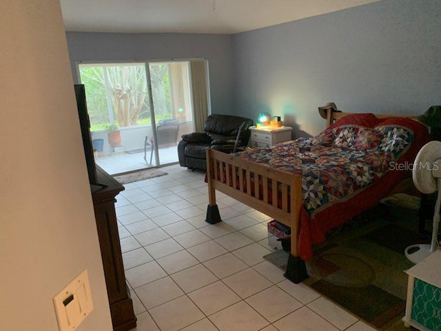 bedroom with access to exterior and light tile patterned flooring