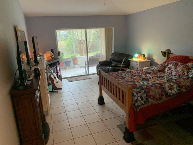 tiled bedroom featuring access to outside