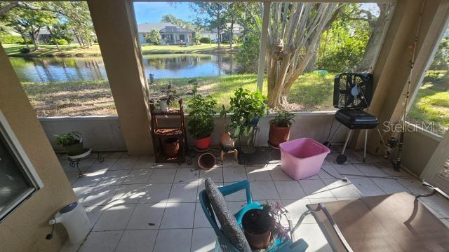 sunroom featuring a water view