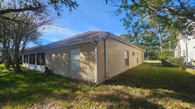 view of side of home featuring a lawn