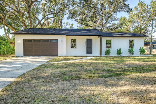 view of front facade with a front yard and a garage