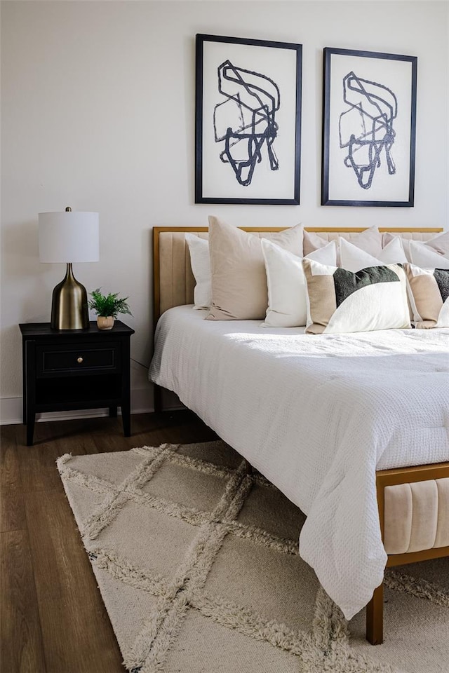 bedroom with dark wood-type flooring