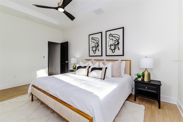 bedroom with hardwood / wood-style flooring and ceiling fan