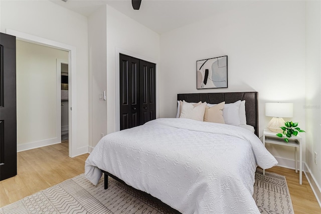 bedroom with hardwood / wood-style flooring, ceiling fan, and a closet