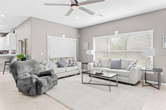 living room featuring ceiling fan and light tile patterned floors