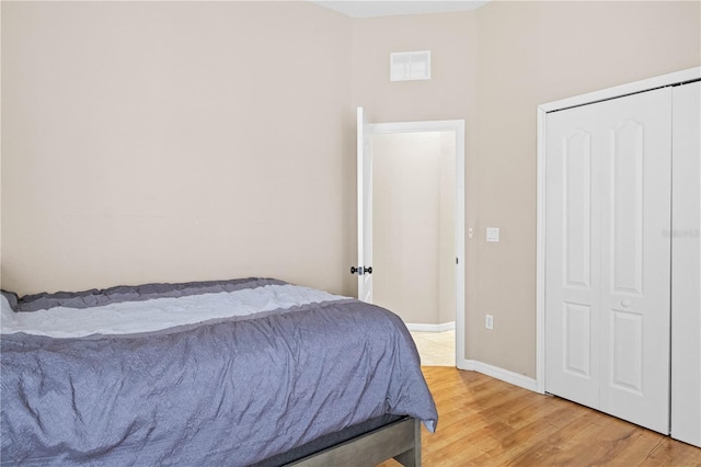 bedroom with a closet and hardwood / wood-style floors