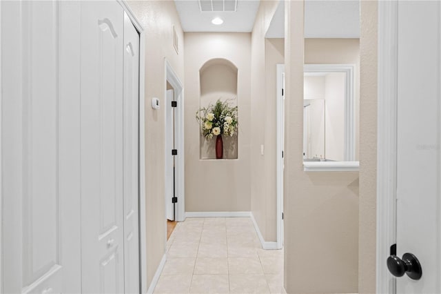 hall featuring light tile patterned floors