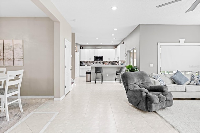 tiled living room featuring ceiling fan