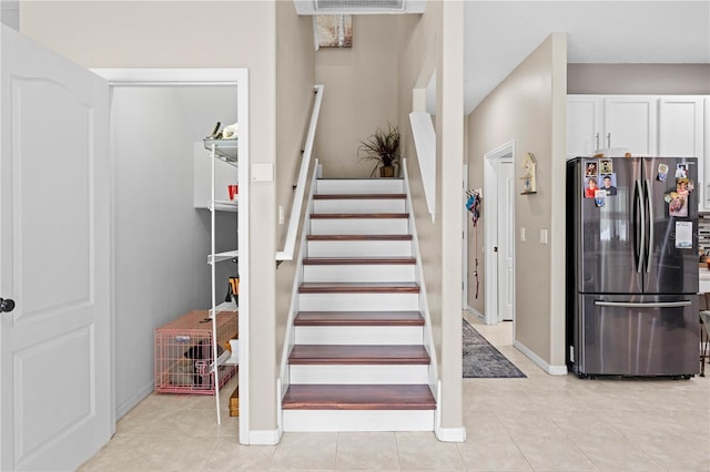 staircase with tile patterned floors