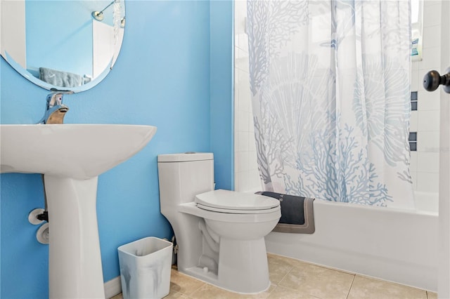 bathroom with tile patterned flooring, shower / bath combination with curtain, and toilet