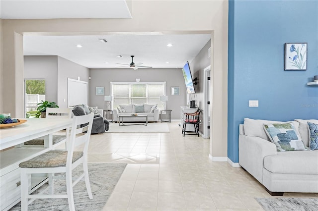 living room featuring light tile patterned floors and ceiling fan