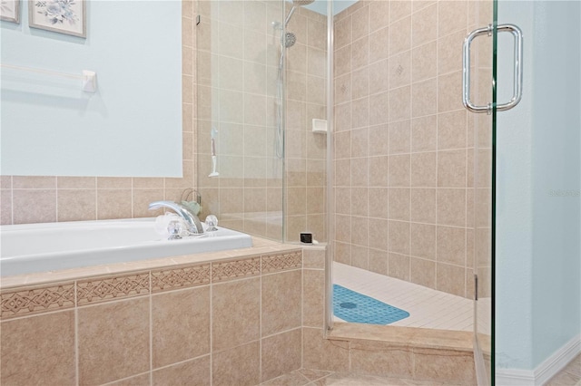 bathroom with shower with separate bathtub