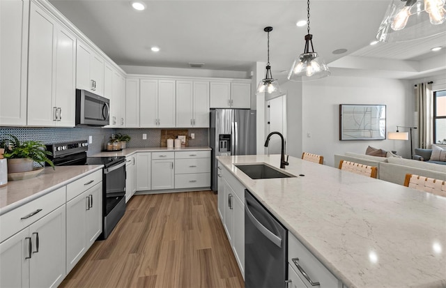 kitchen featuring white cabinets, sink, and stainless steel appliances