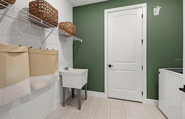 washroom featuring tile patterned flooring and washer / dryer