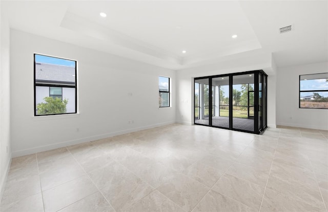 spare room featuring a tray ceiling