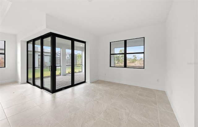 unfurnished room with light tile patterned floors