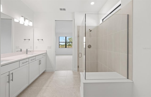 bathroom featuring walk in shower, tile patterned floors, and vanity