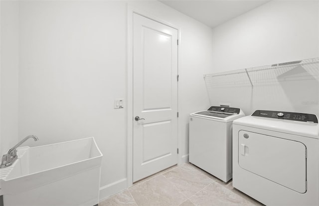 washroom featuring sink and independent washer and dryer