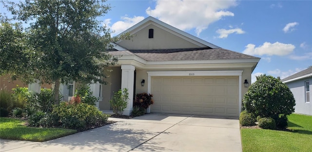 view of front facade featuring a front lawn and a garage