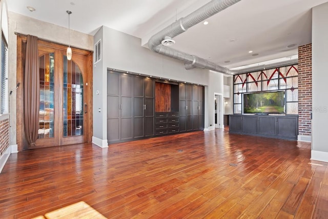 unfurnished living room featuring hardwood / wood-style floors