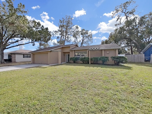 ranch-style house featuring a garage and a front lawn