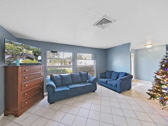 tiled living room with a textured ceiling