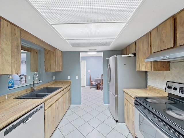 kitchen featuring sink, light tile patterned floors, and stainless steel appliances