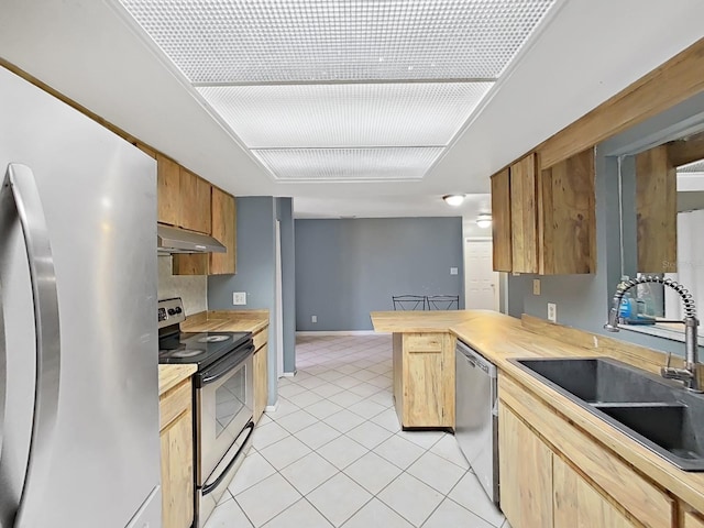 kitchen with kitchen peninsula, stainless steel appliances, sink, light tile patterned floors, and butcher block countertops