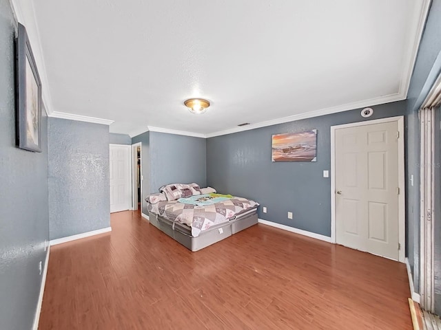 unfurnished bedroom with wood-type flooring and crown molding