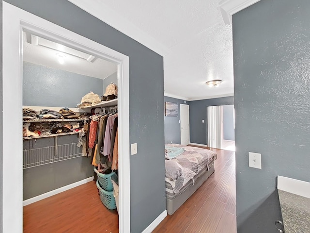 interior space with hardwood / wood-style flooring, ornamental molding, and a closet