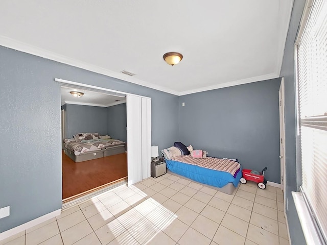 bedroom with light tile patterned floors and ornamental molding