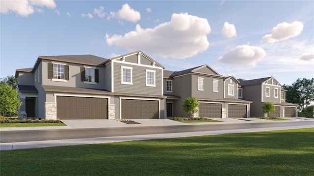 view of front of property with a front yard and a garage